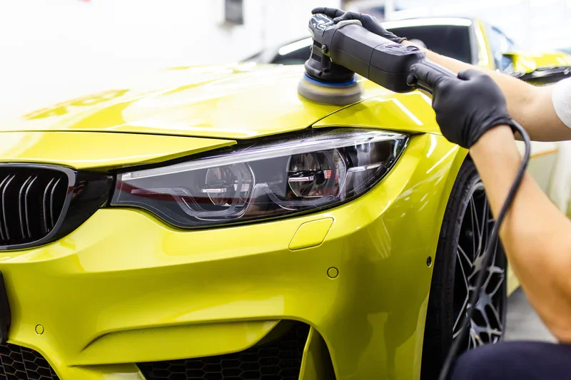 Machine polishing on a yellow vehicle, image from AVA’s existing paint correction page